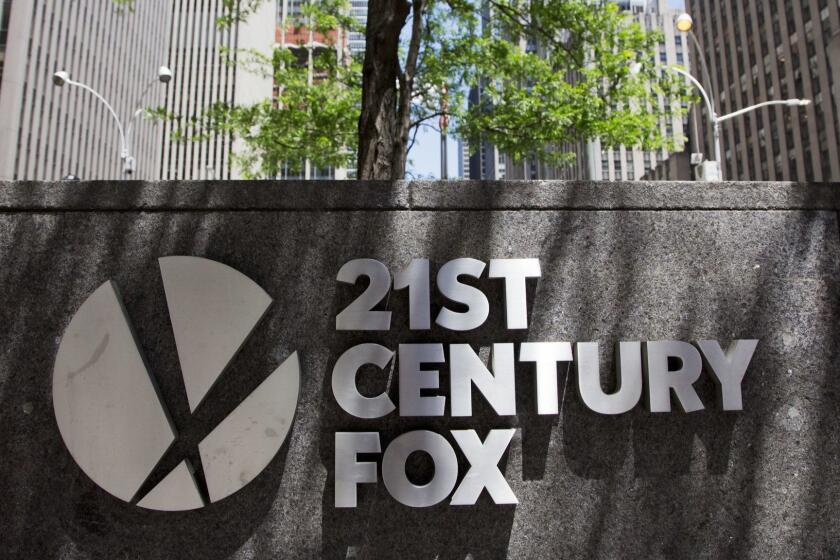 The 21st Century Fox logo is shown outside its New York office, Thursday, June 14, 2018. Competing bids from Comcast and Disney for the bulk of Twenty-First Century Fox come as the media landscape changes and companies get more involved in both creating and distributing content. (AP Photo/Mark Lennihan)