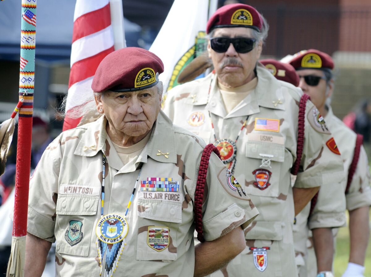 Butch McIntosh, left, leads the Muscogee (Creek) Nation Honor Guard during the opening of a two-day festival in Oxford, Ala., on Friday, April 8, 2022. The Muscogee name for the event is "Reyicepes," or "We have come back," signifying an attempt by the nation to re-establish a presence in the Southeast nearly 200 years after ancestors were forced out of the region to make way for white settlers. (AP Photo/Jay Reeves)