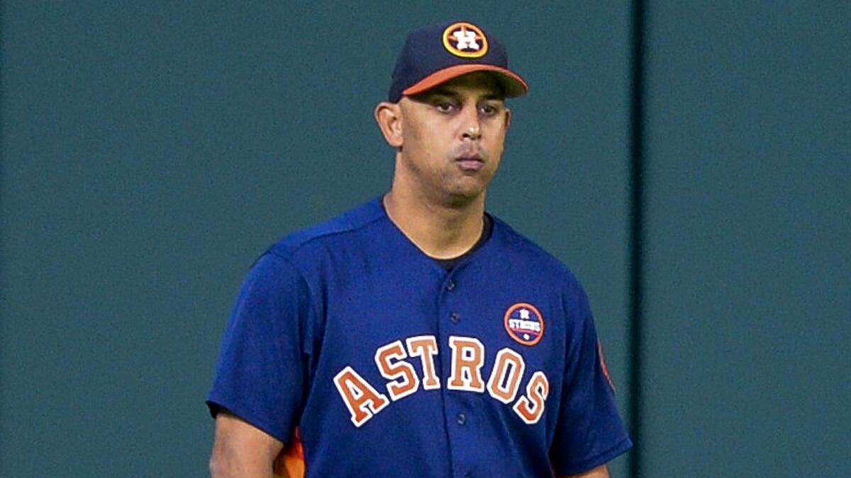 Bench coach Alex Cora watches the Astros prepare for Game 1 of the ALCS.