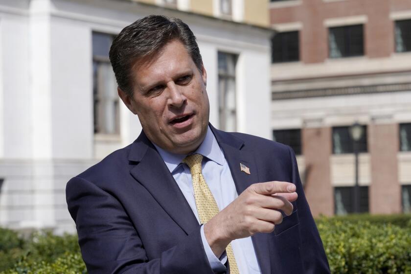 FILE - Republican gubernatorial candidate Geoff Diehl speaks to reporters outside the Statehouse, in Boston, March 21, 2022. Diehl, who has former President Donald Trump’s endorsement, is going up against businessman Chris Doughty, a political newcomer, in the Republican primary for governor on Tuesday, Sept. 6. (AP Photo/Steven Senne, File)