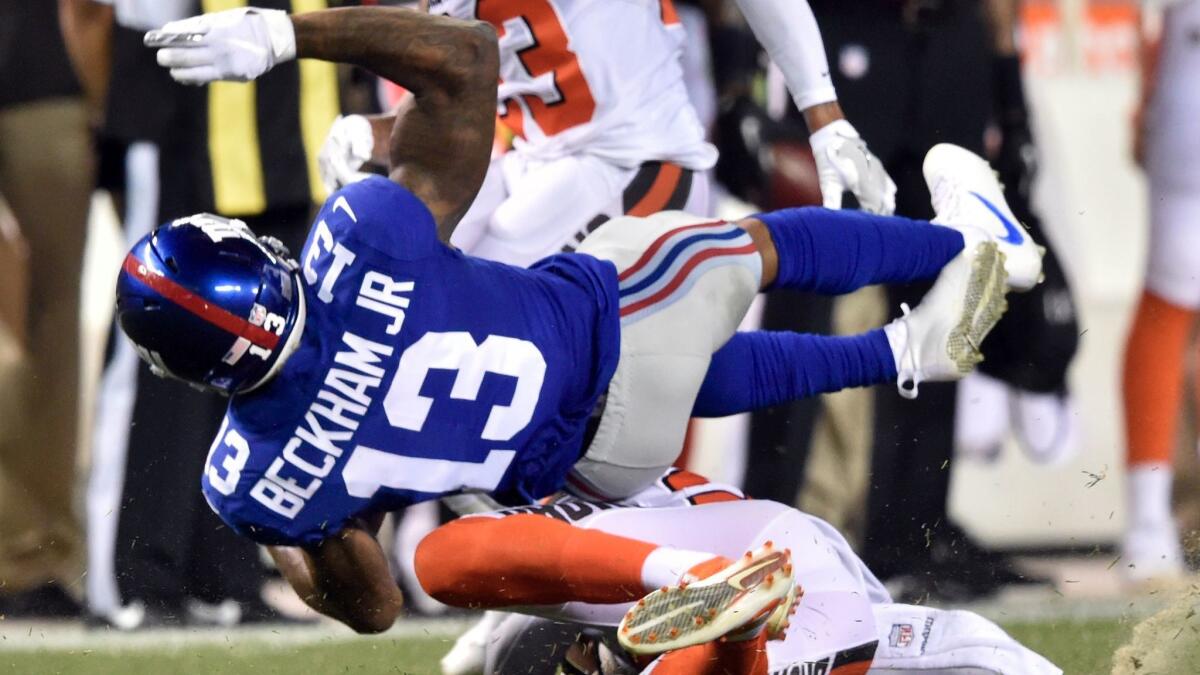 New York Giants wide receiver Odell Beckham is tackled by Cleveland Browns defensive back Briean Boddy-Calhoun on Aug. 21.