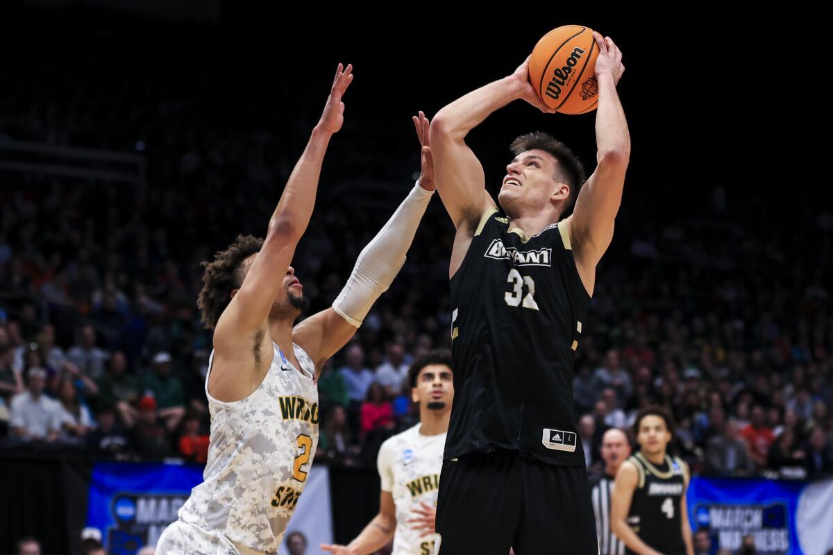 Bryant's Peter Kiss drives to the basket against Wright State's Tanner Holden.