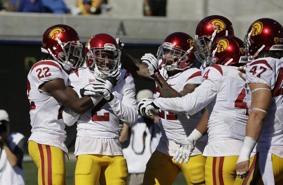 USC cornerback Adoree' Jackson, second from left, is greeted by teammates after returning an interception 46 yards for a touchdown against California.