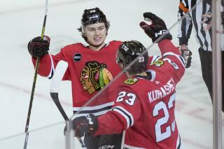Chicago Blackhawks' Philipp Kurashev (23) celebrates after his goal off an assist by Connor Bedard, left, during the second period of the team's NHL hockey game against the Anaheim Ducks, Thursday, Dec. 7, 2023, in Chicago. (AP Photo/Charles Rex Arbogast)