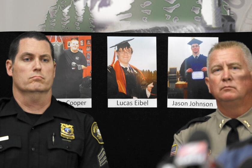 Portland Police Sgt. Peter Simpson, left, and Douglas County Sheriff John Hanlin at a news conference in Roseburg with photos of three victims: Quinn Cooper, Lucas Eibel and Jason Dale Johnson, from left.