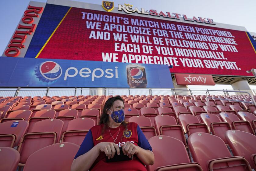 A fan sits in the stands after the scheduled game between Real Salt Lake and Los Angeles FC was postponed Wednesday, Aug. 26, 2020, in Sandy, Utah. Major League Soccer players boycotted five games Wednesday night in a collective statement against racial injustice. The players' action came after all three NBA playoff games were called off in a protest over the police shooting of Jacob Blake in Wisconsin on Sunday night. (AP Photo/Rick Bowmer)