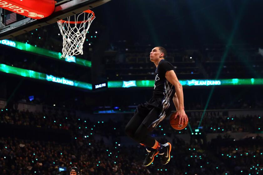 Minnesota rookie Zach LaVine brings the ball behind his back before dunking during the All-Star contest on Saturday.