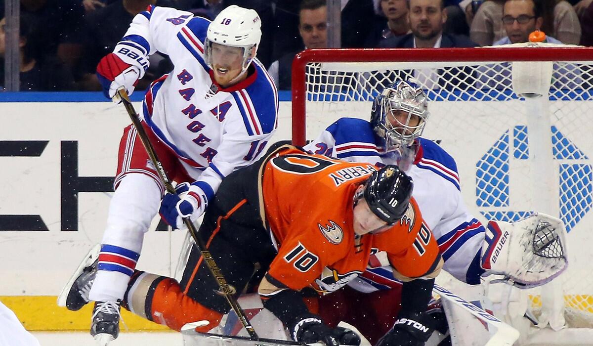 The New York Rangers' Marc Staal, left, and Henrik Lundqvist defend against Anaheim's Corey Perry during the second period Tuesday.
