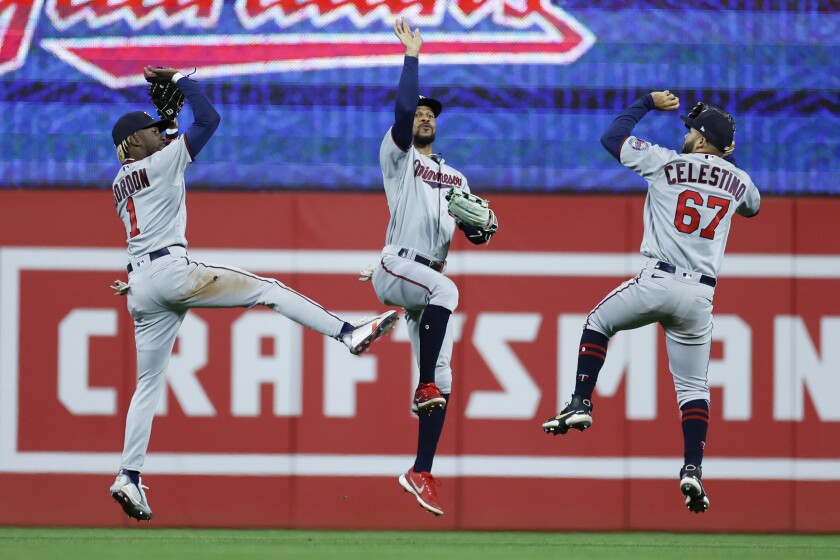 Minnesota Twins left fielder Nick Gordon (1), center fielder Byron Buxton and left fielder Gilberto Celestino (67) celebrate a win against the Cleveland Guardians in the second baseball game of a doubleheader, Tuesday, June 28, 2022, in Cleveland. (AP Photo/Ron Schwane)