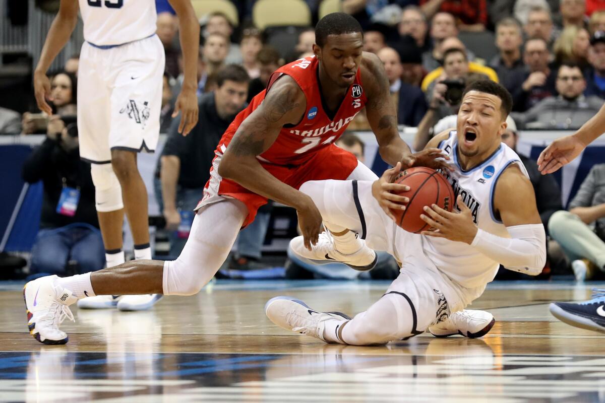 Villanova's Jalen Brunson, right, fights for the ball against Radford's Ed Polite Jr. (24) in the first round of the NCAA tournament.