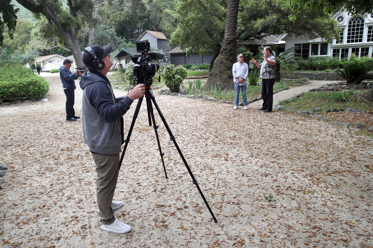 Chris Epting and John Moorlach, from left, film a segment for "OC History Hunters" the Modjeska Historic House and Gardens.
