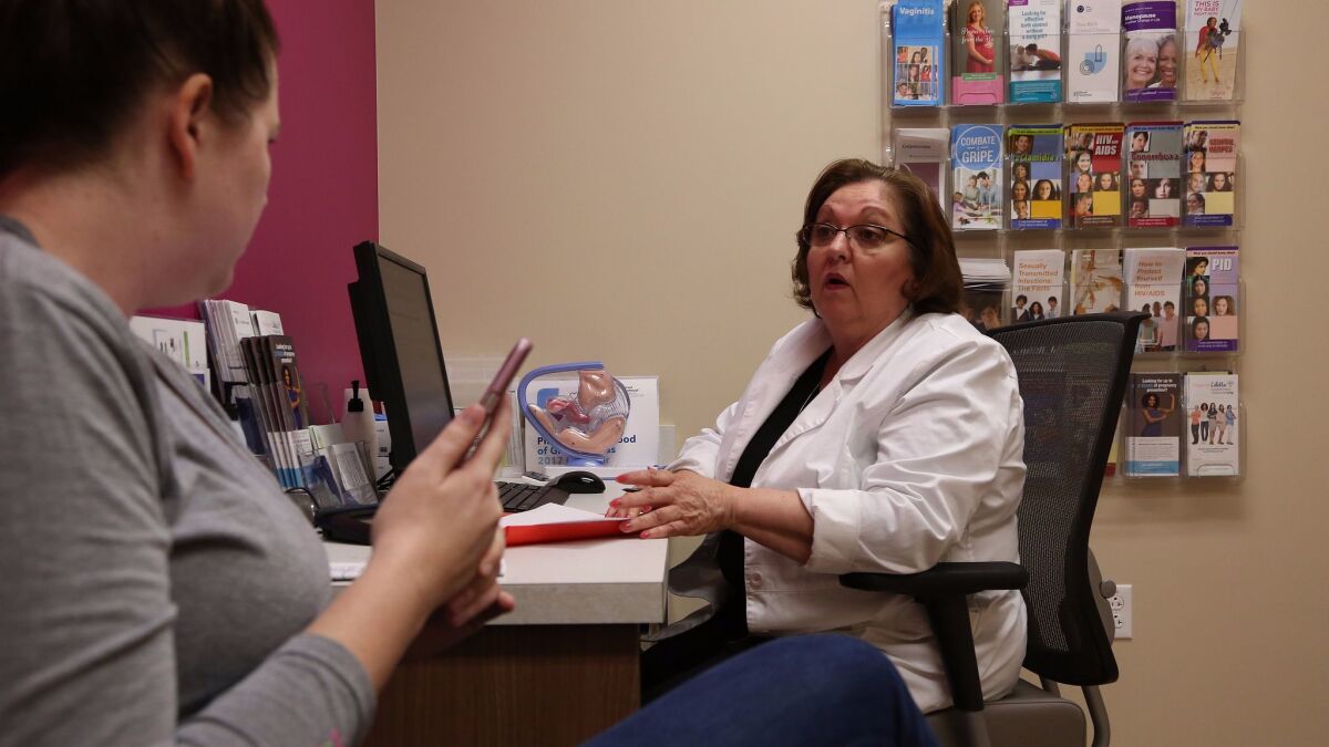 Vivian Bigelow, a nurse practitioner, discusses birth control options with a patient at a Planned Parenthood health center in Plano, Texas. The Republican healthcare plans would prohibit Medicaid recipients from using their benefits at Planned Parent facilities for one year. (Katie Falkenberg / Los Angeles Times)
