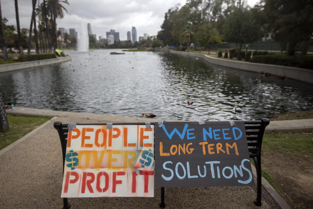 A sign sits in a mostly empty Echo Park