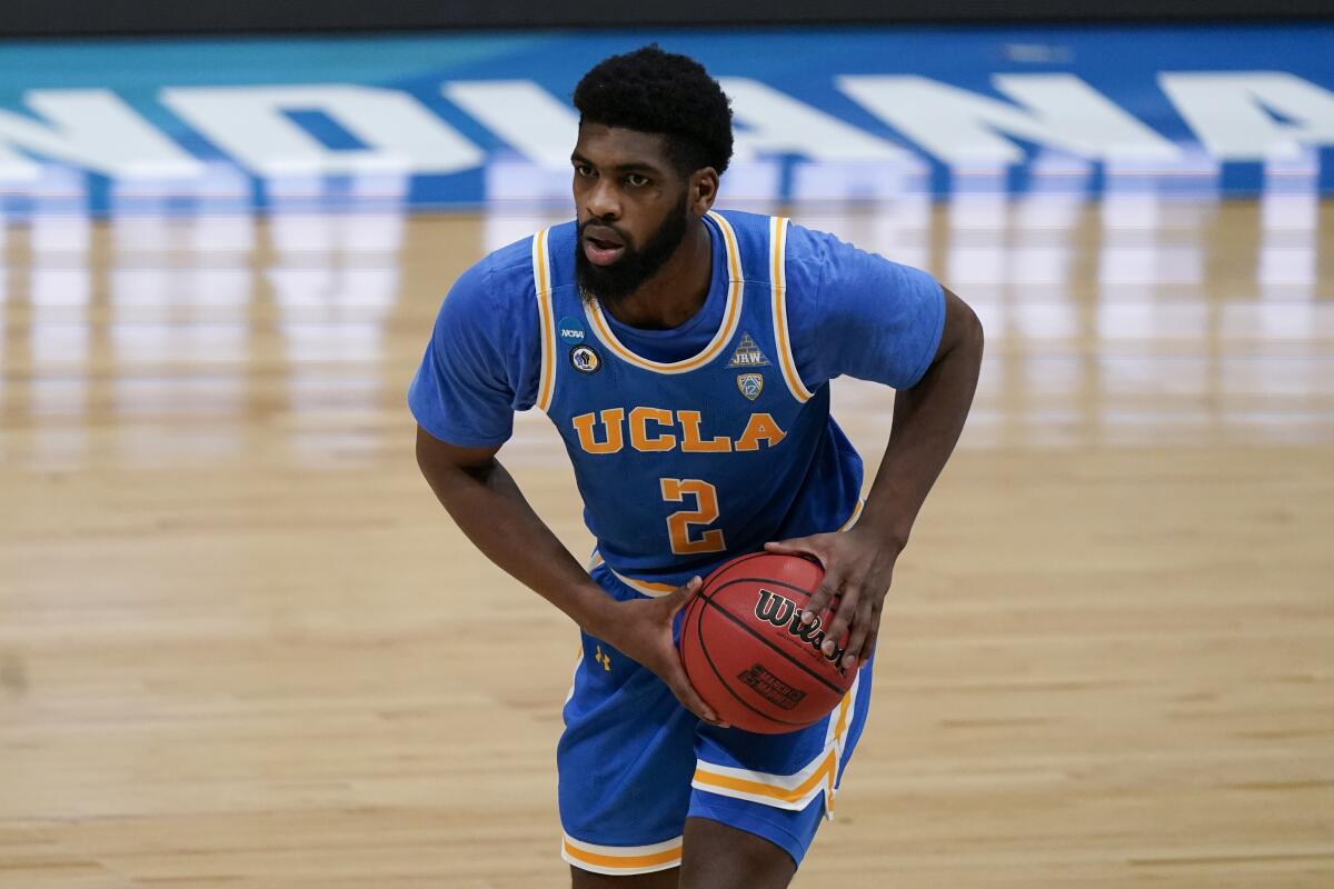 UCLA forward Cody Riley looks to pass against Michigan on Tuesday.