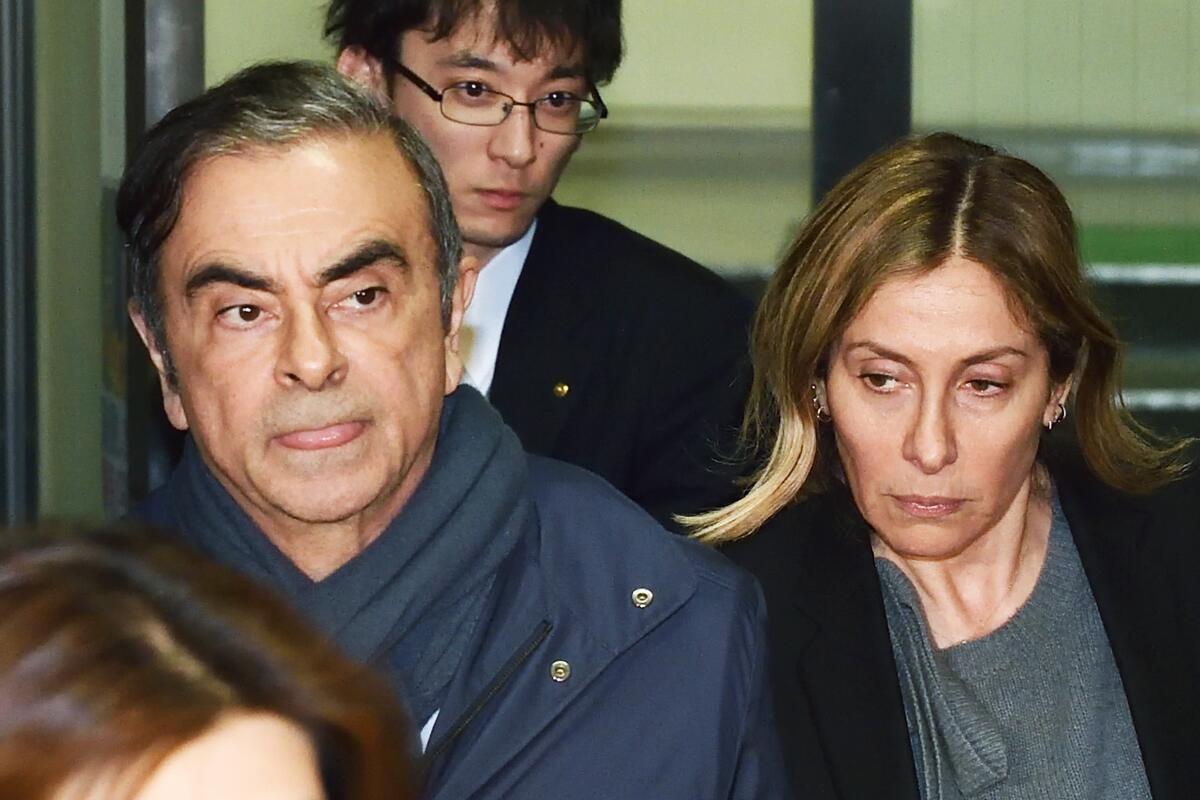 Former Nissan Chairman Carlos Ghosn and his wife Carole leave a lawyer's office in Tokyo on April 3. 