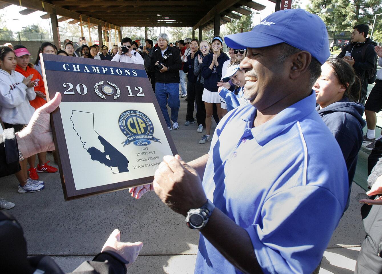 San Marino head girls tennis coach Melwin Pereira is given the Champions CIF trophy after defeating Arcadia in the CIF Southern Section Ford Girls Tennis Team Championships, Division 2, at the Claremont Club in Claremont on Friday, November 9, 2012.
