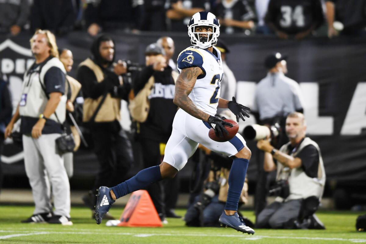 Los Angeles Rams cornerback Marcus Peters runs to the endzone after an interception of Derek Carr in the fourth quarter at Oakland-Alameda County Coliseum.