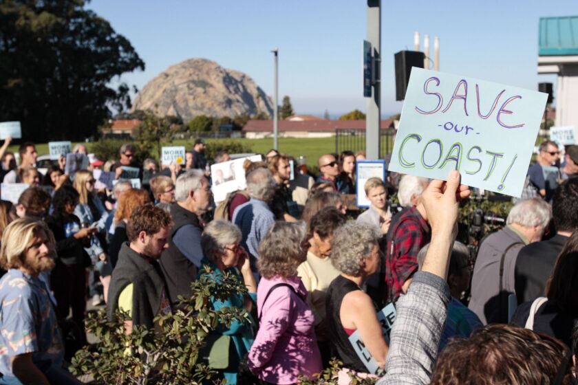 A vote on the dismissal of California Coastal Commission Executive Director Charles Lester is on the agenda at a meeting in Morro Bay. Supporters gather outside the Morro Bay Community Center before hearing Wednesday, Feb. 10, 2016. (David Middlecamp/The Tribune (of San Luis Obispo) via AP)