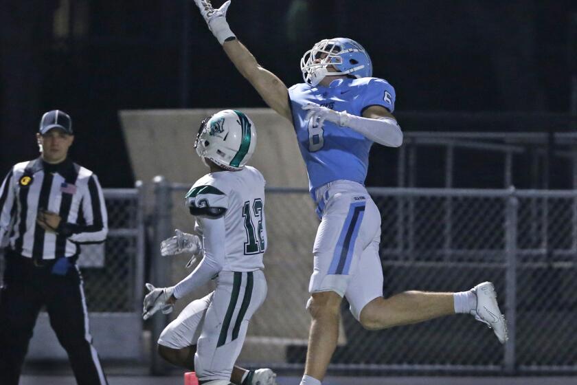 Corona del Mar's John Humphreys stretches out for a pass from Ethan Garbers in the CIF State Southern California Regional Division 1-A Bowl Game against Oceanside at Newport Harbor High on Saturday. PHOTO BY CHRISTINE COTTER/CONTRIBUTING PHOTOGRAPHER