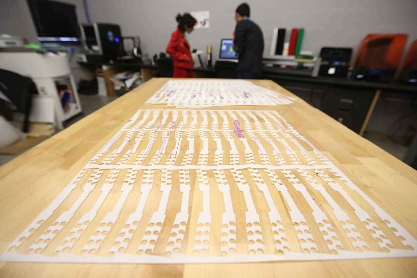 Ear saver clips are shown being made in the Laguna College of Art and Design's Fabrication Lab on Wednesday.