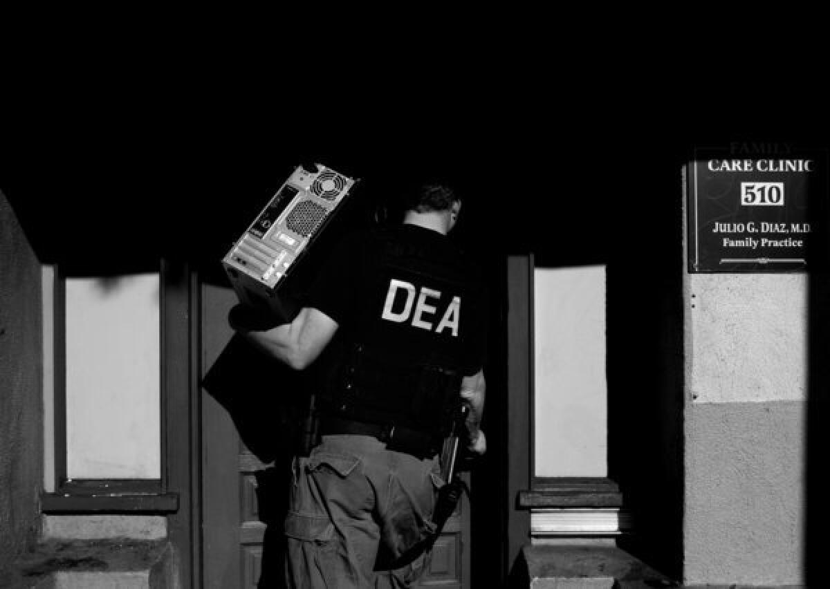 SANTA BARBARA, CA - WEDNESDAY, JANUARY 4, 2012 -- Agents remove evidence including computers from family physician Julio Diaz's office in Santa Barbara during a search Wednesday, January 4, 2012. Diaz was arrested earlier on federal drug charges following complaints about overdose deaths among patients. ( Liz O. Baylen / Los Angeles Times)