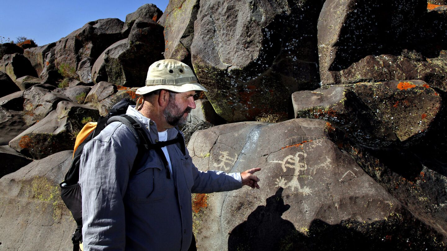 Michael Baskerville, 51, examines a petroglyph at Little Petroglyph Canyon.