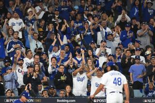 Los Angeles, CA - October 09: Dodger fans celebrate Brusdar Graterol efforts.