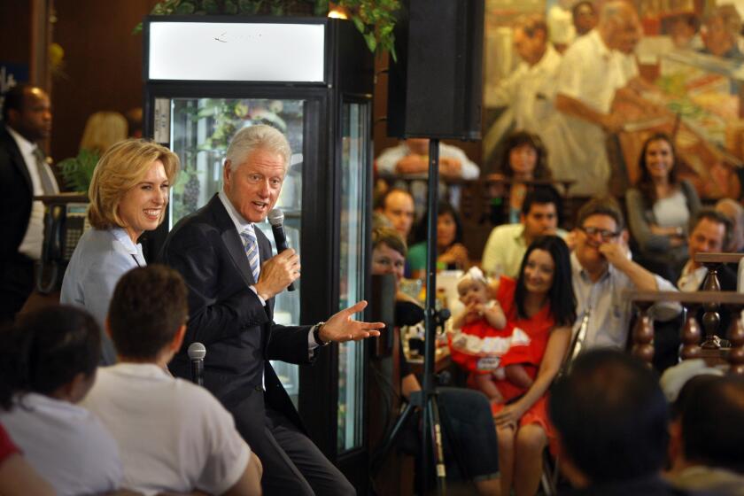 Former President Bill Clinton, center, appears in support of Los Angeles mayoral candidate Wendy Greuel, left, at Langer's Delicatessen on Saturday.