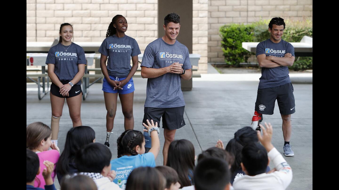 Team USA long jumper Trenten Merrill, center, answers questions from kids at Woodbury Elementary School in Irvine on Thursday, April 11, 2019. Background from left is Team Canada sprinter Marissa Papaconstantinou, Team USA sprinter Femita Ayanbeku and Team USA cyclist and triathlete Mo Lahna. April is National Limb Loss Awareness Month.
