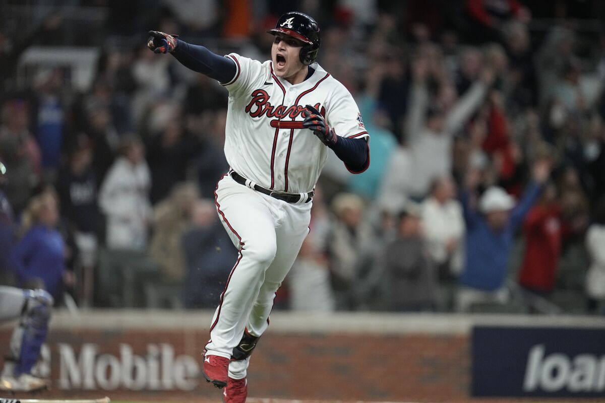 Atlanta Braves' Austin Riley reacts after hitting the game winning RBI single to score Atlanta Braves' Ozzie Albies in the ninth inning in Game 1 of baseball's National League Championship Series against the Los Angeles Dodgers Saturday, Oct. 16, 2021, in Atlanta. The Braves defeated the Dodgers 3-2 to take game 1. (AP Photo/Ashley Landis)