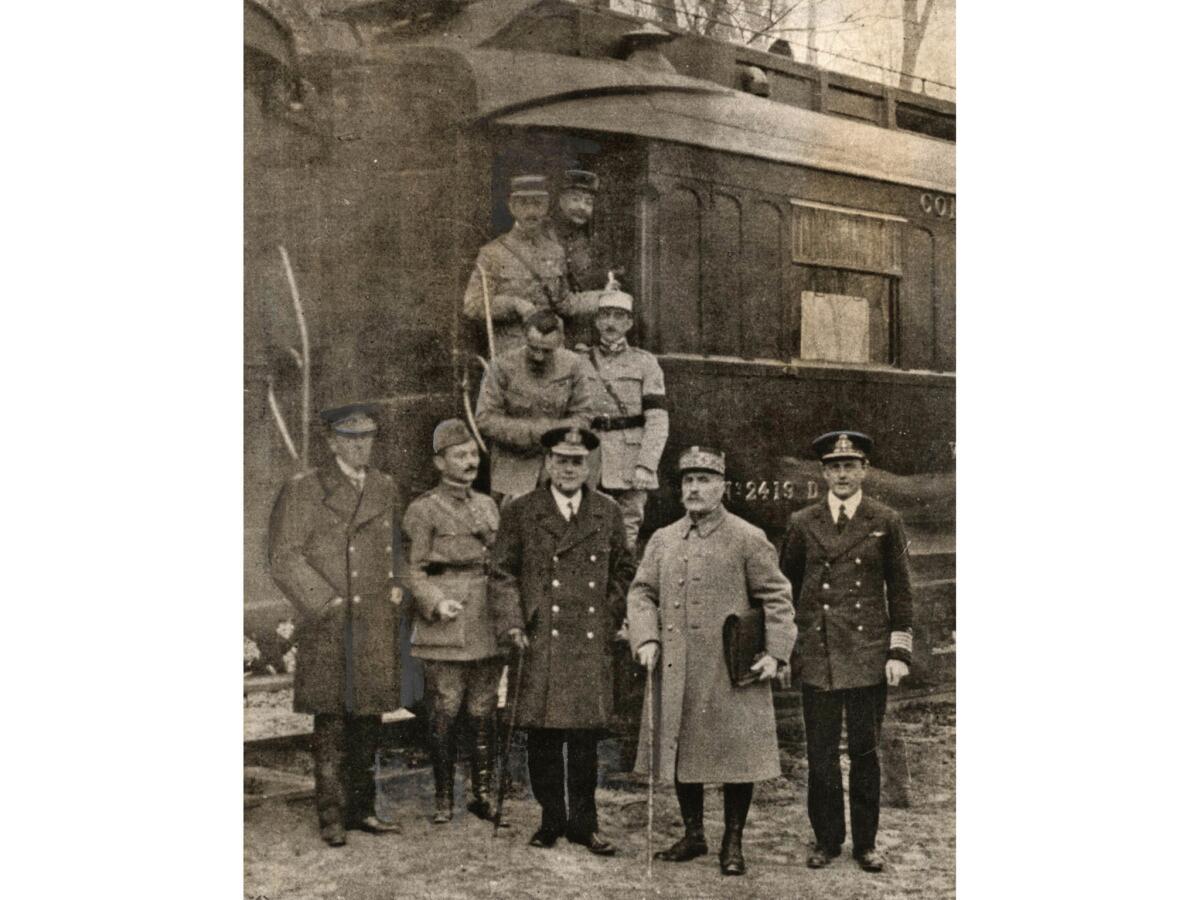 Nov. 11, 1918: Soldiers dismount the railroad car in which the armistice ending World War I was signed. Gen. Maxime Weygand of France is second from left and Gen. Marshal Foch of France is second from right.