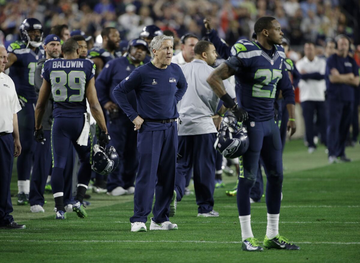 Seahawks Coach Pete Carroll watches as players react following Malcolm Butler's interception of a pass by Russell Wilson.