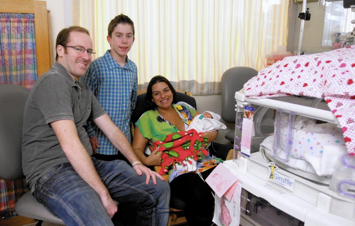 Twelve-year-old Jonah Retin, center, made blankets for babies in the Neonatal Intensive Care Unit at Glendale Adventist Medical Center.