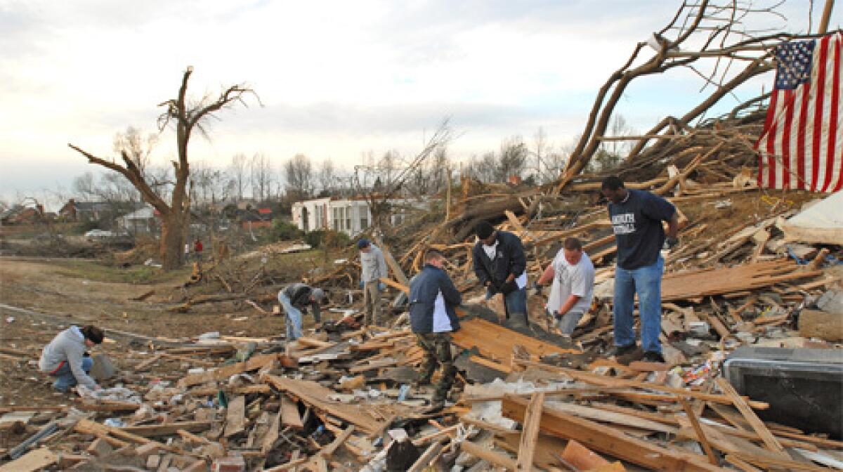 CAMPUS SHATTERED: Students from Lambuth University in Jackson, Tenn., search the rubble left by a tornado. Another Jackson college, Union University, was also hit hard. Weather officials said as many as 63 tornadoes struck in three states alone.