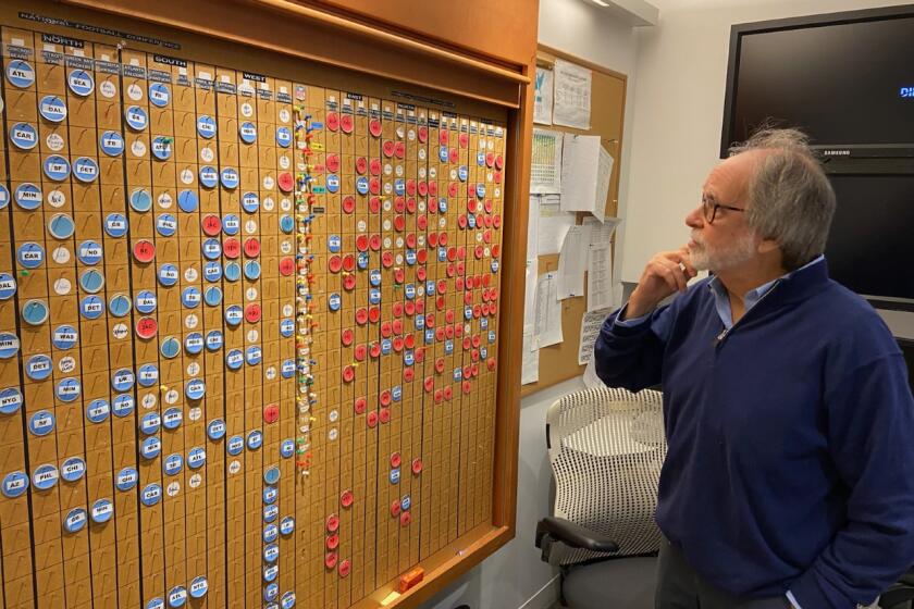 Howard Katz looks over the old NFL scheduling board from offices in New York.