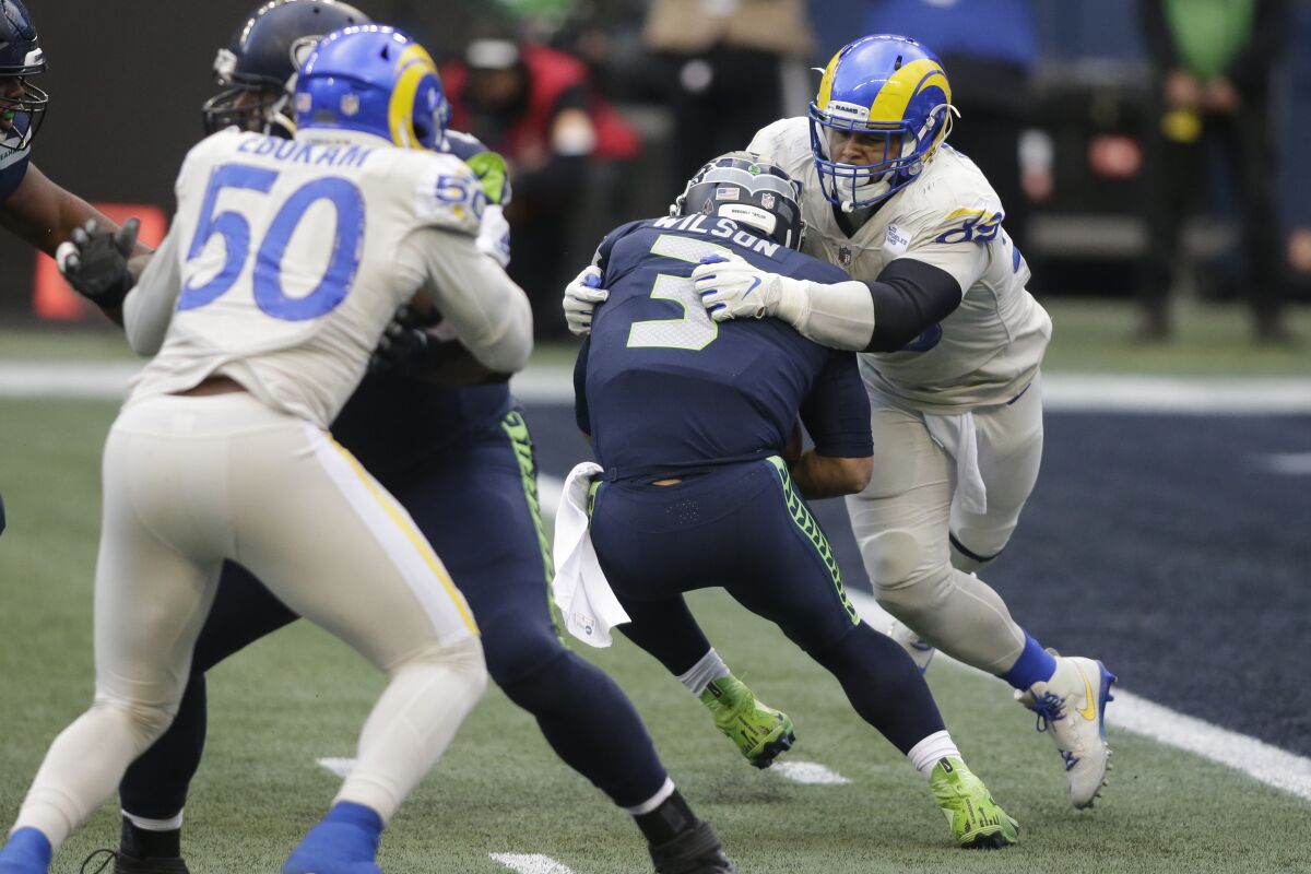 Seattle Seahawks quarterback Russell Wilson is sacked by Rams defensive tackle Aaron Donald.