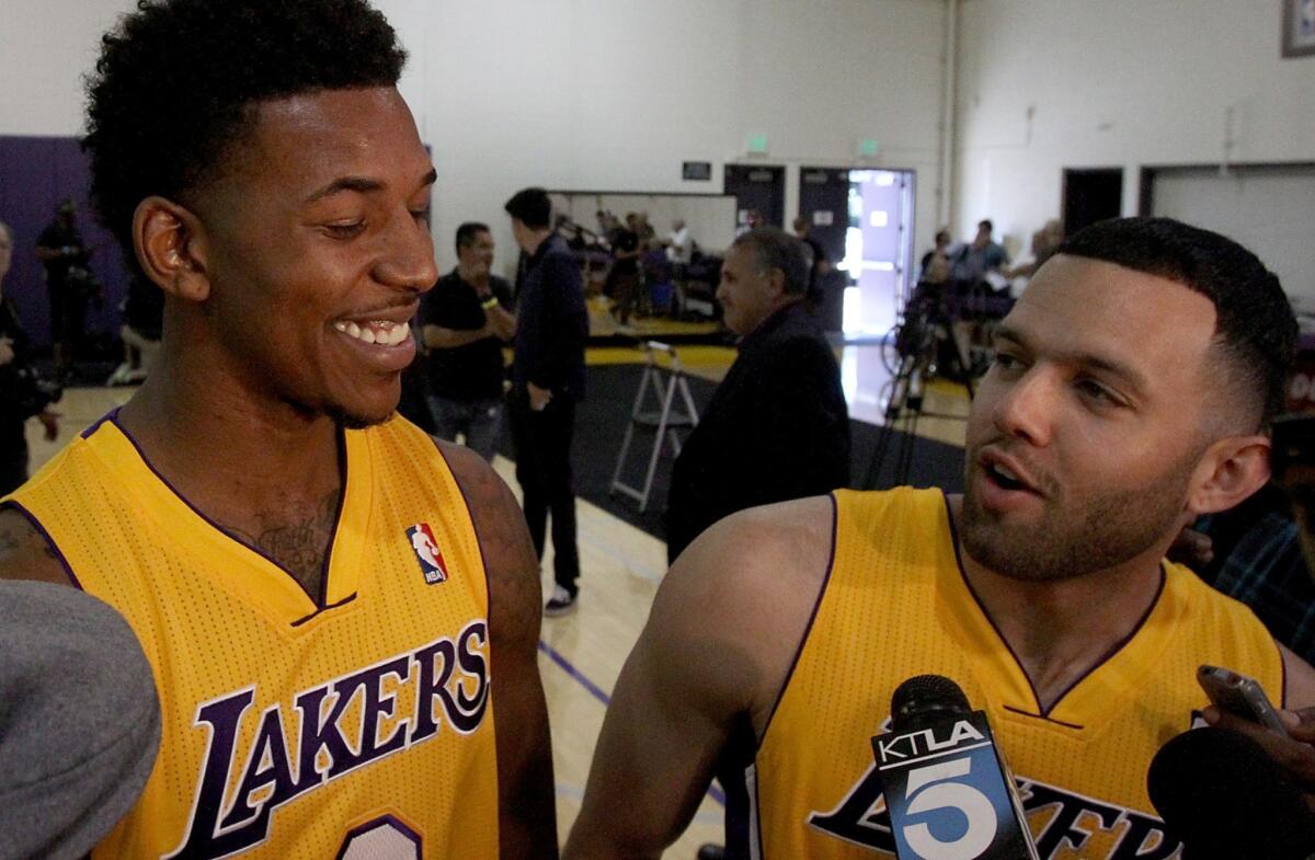Lakers guard Nick Young, left, and teammate Jordan Farmar share a light-hearted moment during team media day on Saturday. Farmar extended a helping hand to Young in high school.