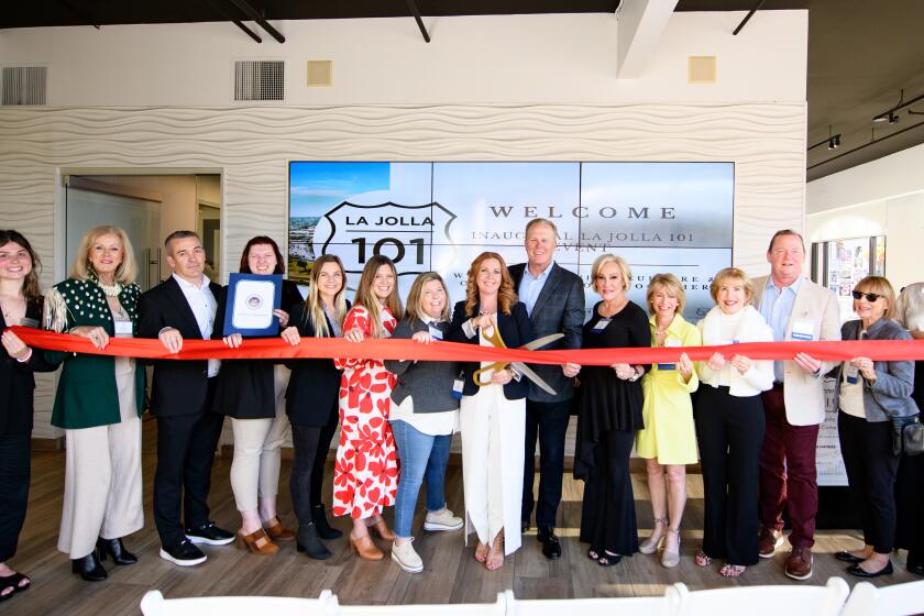 Participants in the March 14 debut of "La Jolla 101" cut the ribbon to start the festivities.