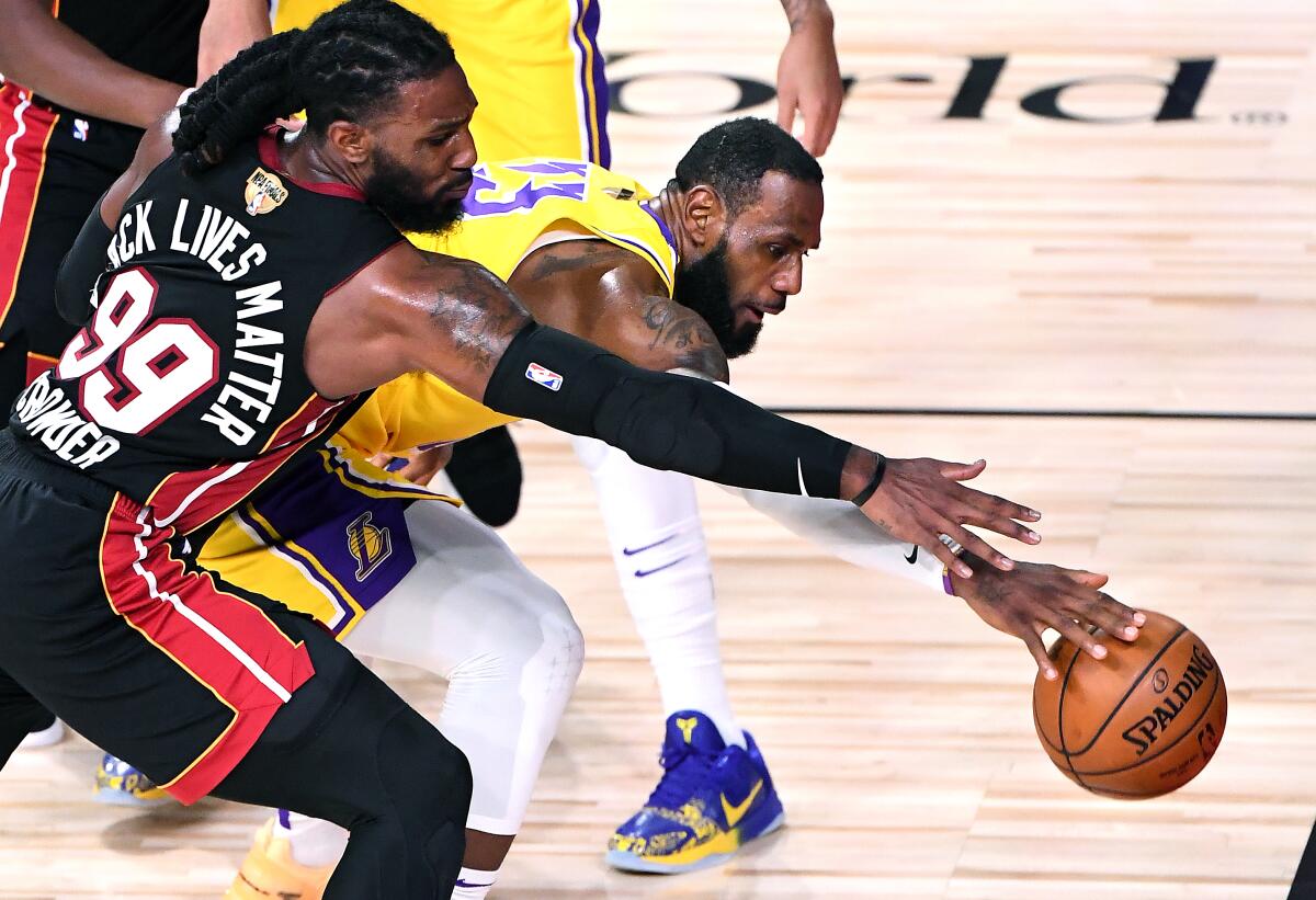 Lakers LeBron James and Miami Heat's Jae Crowder battle for a loose ball.