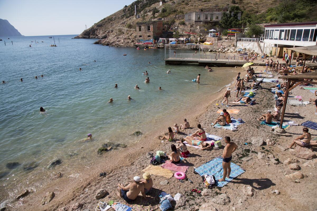 People gather at a beach area of the Black Sea.
