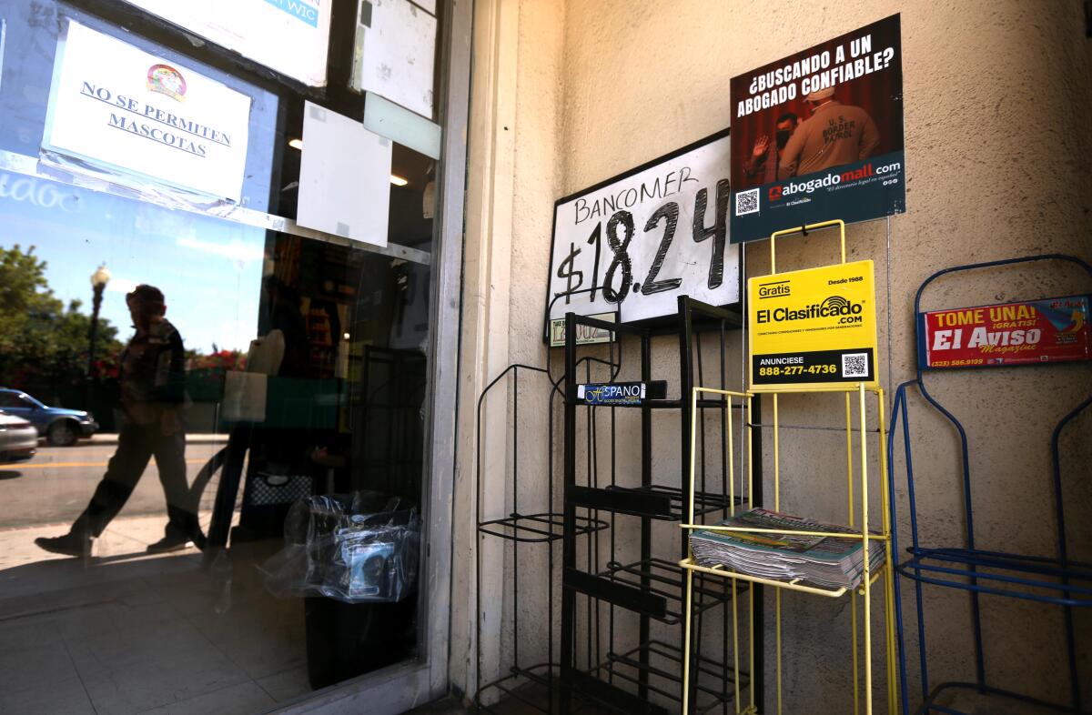 Mostly empty news racks outside a market in downtown Santa Ana.