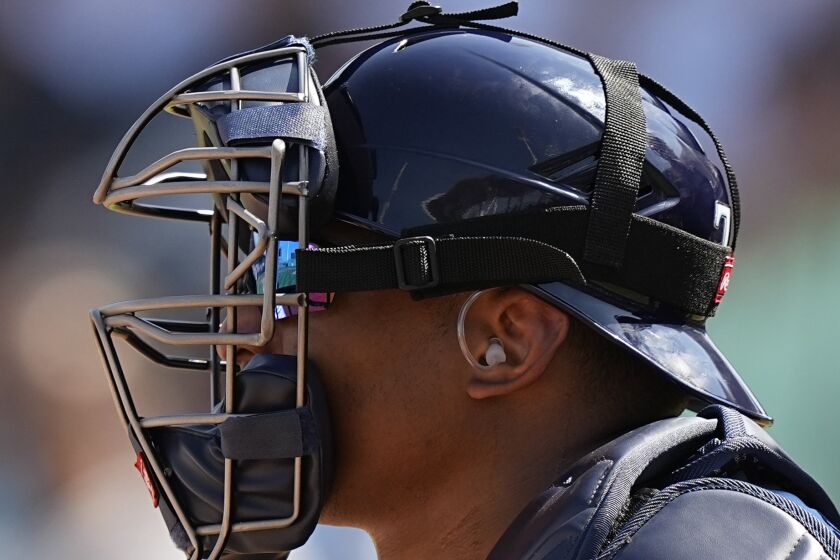 Tampa Bay Rays catcher Christian Bethancourt (14) wears a PitchCom in his ear during a spring training baseball game against the Boston Red Sox, Sunday, Feb. 26, 2023, in Fort Myers, Fla. (AP Photo/Brynn Anderson)