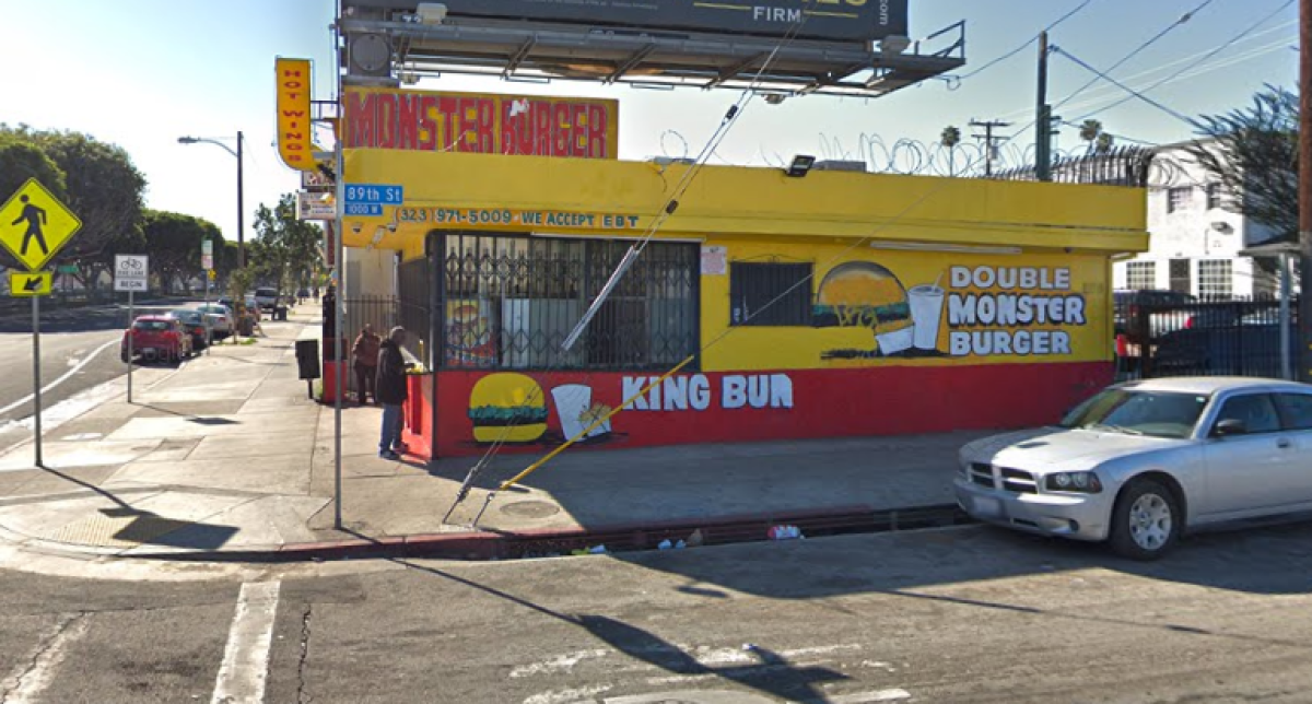 A man was shot in the hand while standing in the parking lot of Monster Burger in South Los Angeles.