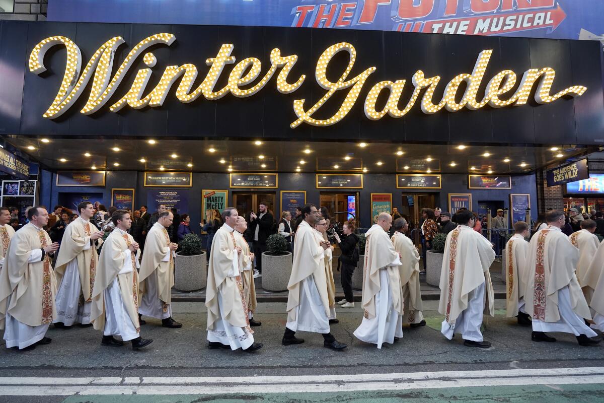 Priests participate in a Eucharistic procession through Midtown Manhattan in New York City.