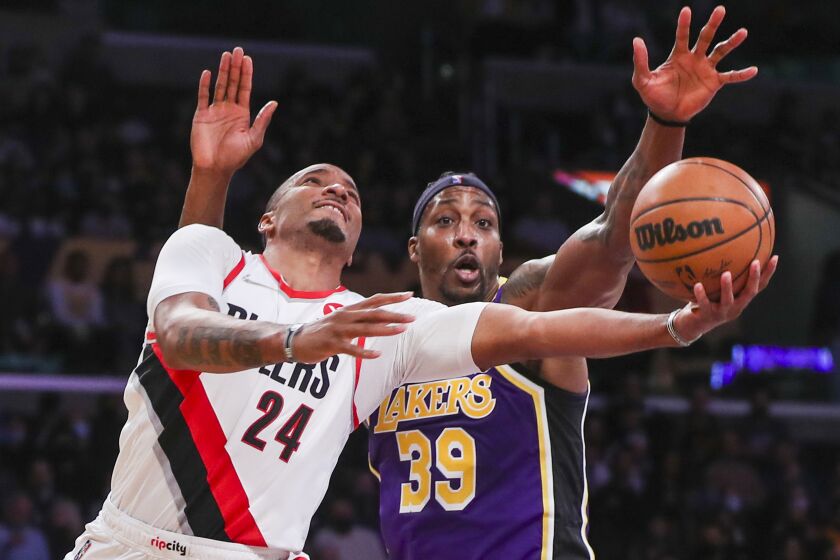 Los Angeles, CA - February 02: Los Angeles Lakers center Dwight Howard, right, battles Portland Trail Blazers forward Norman Powell as he goes up for a basket in the second half at Crypto.com Arena in Los Angeles Wednesday, Feb. 2, 2022. Lakers won 94-99. (Allen J. Schaben / Los Angeles Times)