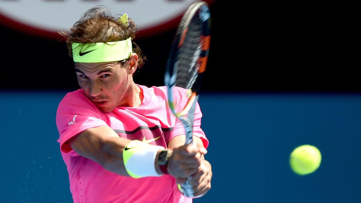 Rafael Nadal returns a shot during his first-round win over Mikhail Youzhny at the Australian Open on Monday.