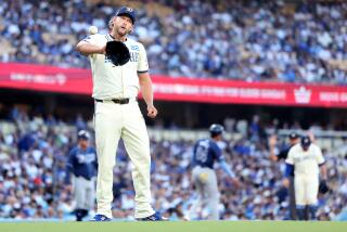 Dodgers pitcher Clayton Kershaw walks back to the mound after giving up a run to the Rays at Dodger Stadium.