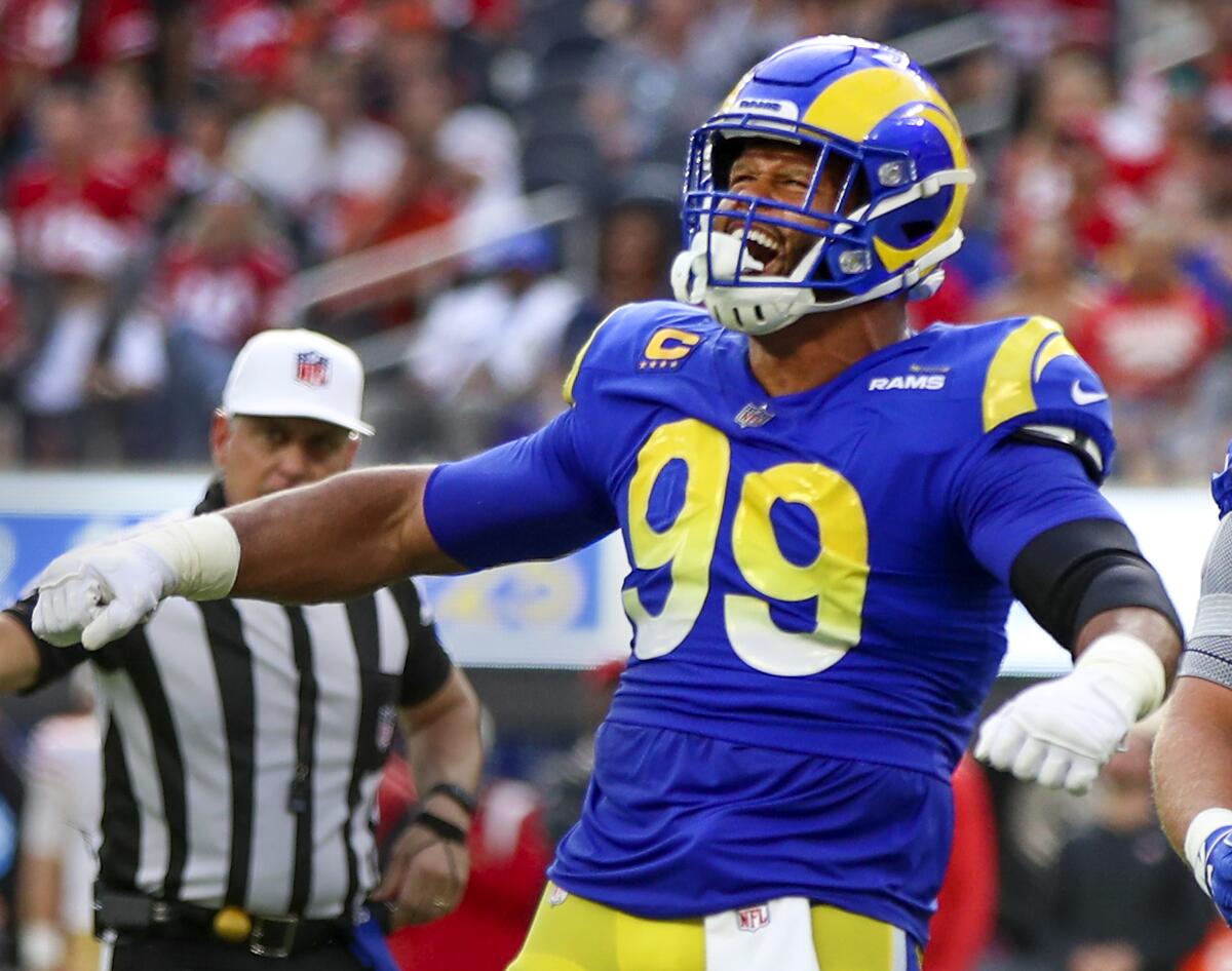 Rams defensive lineman Aaron Donald celebrates sacking 49ers quarterback Jimmy Garoppolo in 2022.