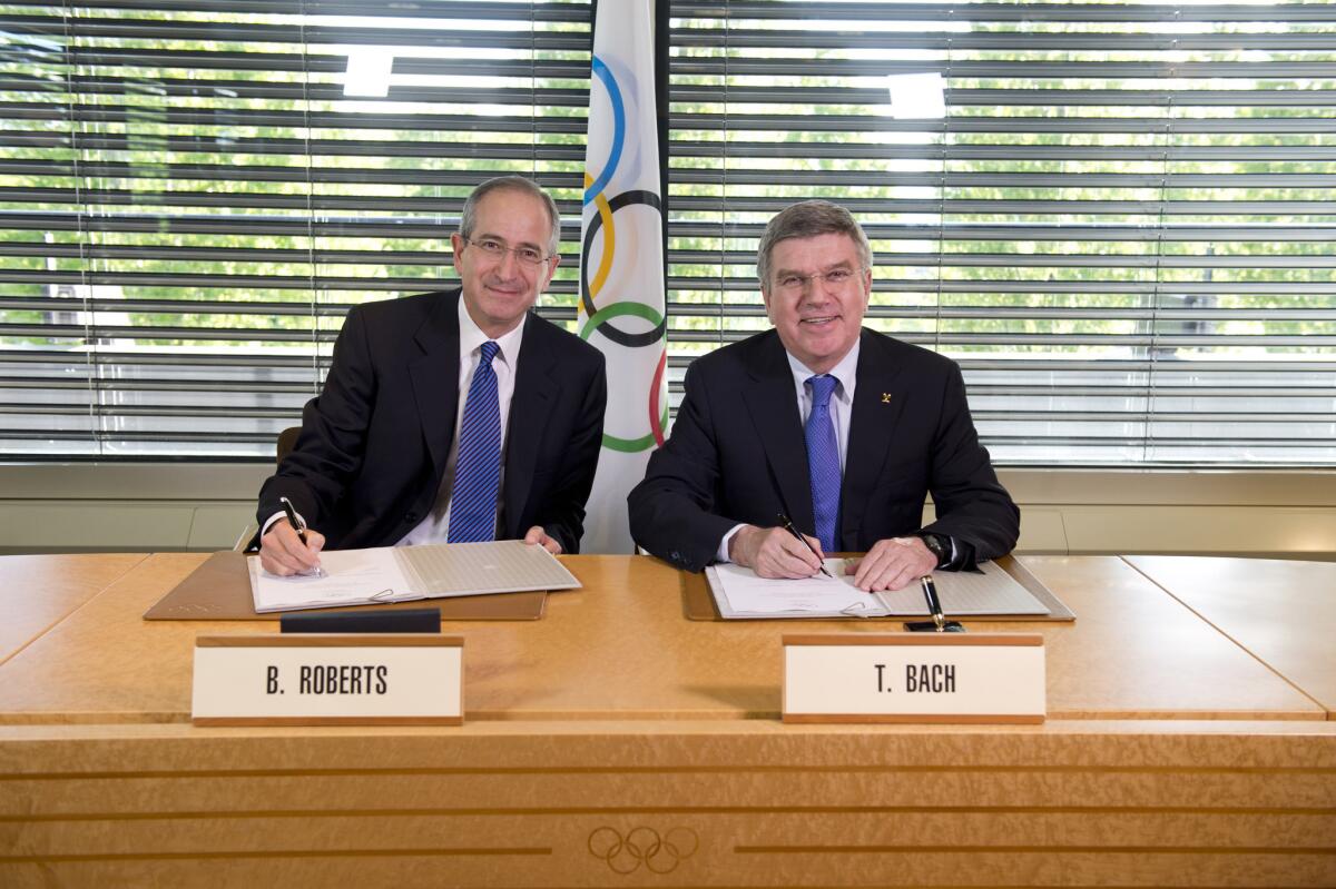 IOC President Thomas Bach and Chairman and Chief Executive of Comcast Corp. Brian L. Roberts pose for a photograph on May 7.