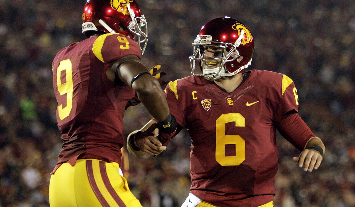 USC wide receiver JuJu Smith (9) and quarterback Cody Kessler (6) celebrate after Kessler threw a 32-yard touchdown pass to George Farmer (not pictured) against California on Thursday night.